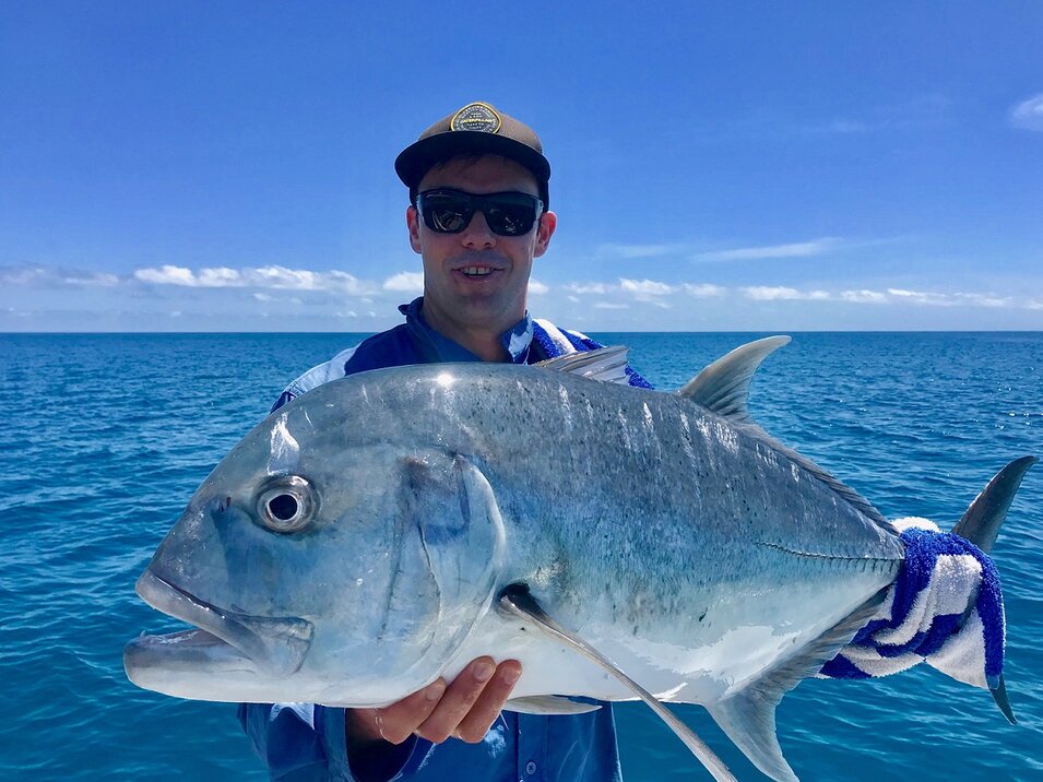male angler with trevally fish