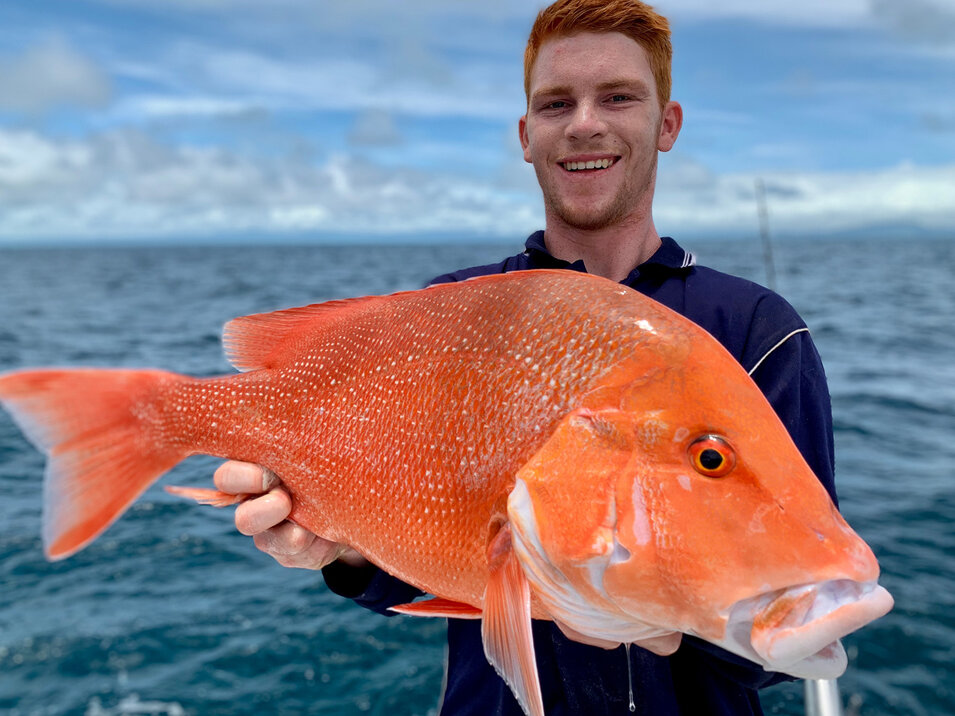 male angler holding his reef fish catch