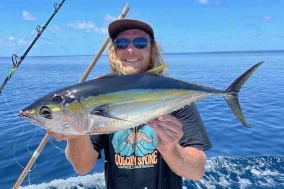 Angler holding a freshly caught tuna
