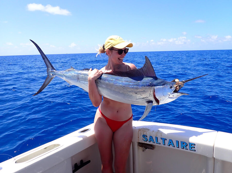 Angler holding a freshly caught juvenile Marlin
