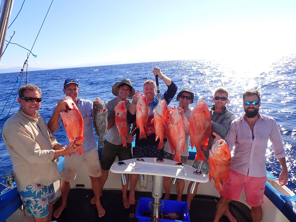 Six anglers showing their freshly caught fish