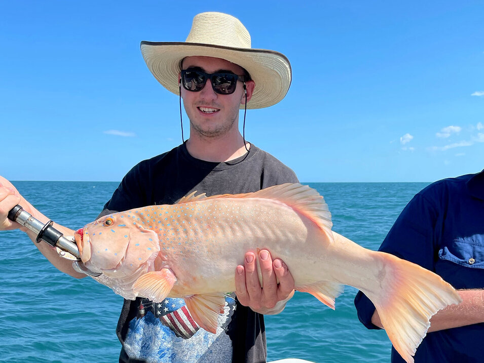 Angler holding a freshly caught Coral trout