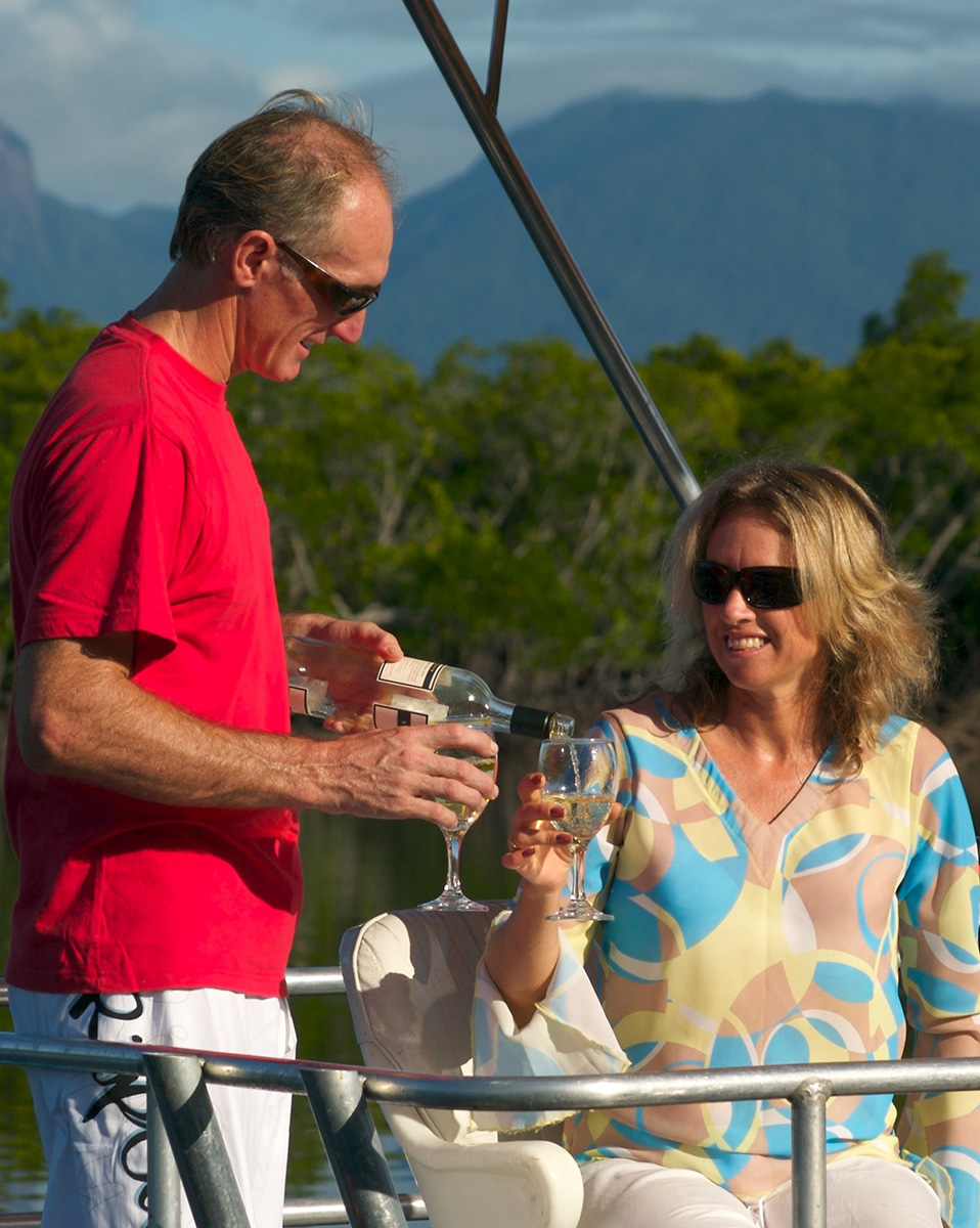 man and woman drinking wine on the Port Douglas pontoon boat