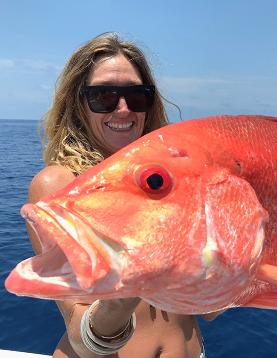 An angler showing her freshly caught Red emperor fish