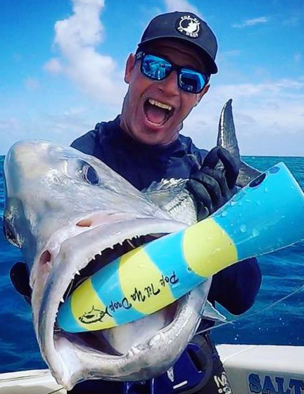 A proud angler showing his freshly caught Giant trevally fish