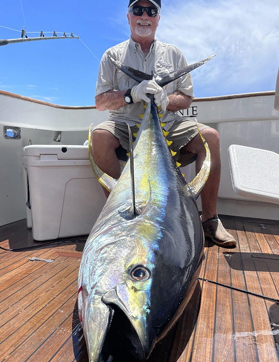 An angler showing his freshly caught Yellowfin tuna fish